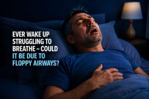 Person sleeping on their back experiencing breathing difficulties, illustrating a blog post about floppy airways and airway collapse during sleep.